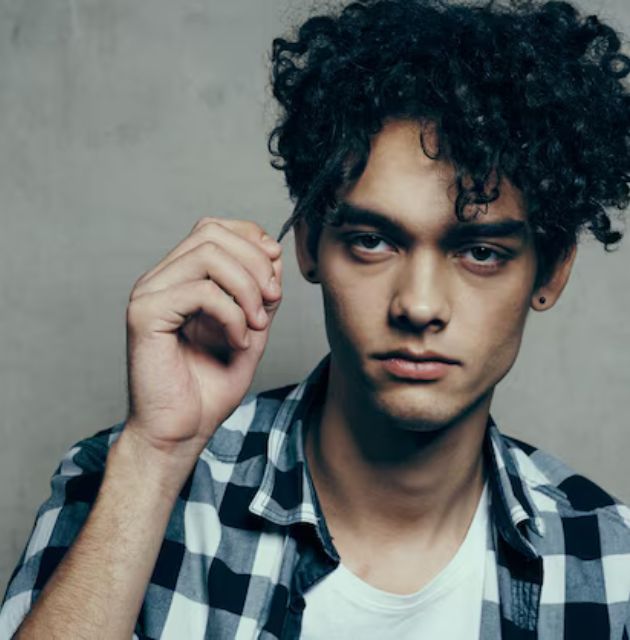 "Short curly hairstyles for men with messy curls, offering a relaxed and effortlessly stylish look that embraces natural texture."