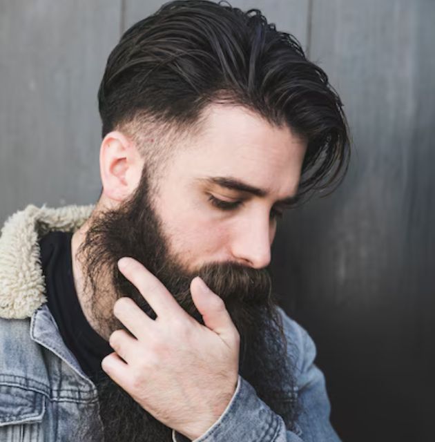 "Mohawk with tapered sides for men's short curly haircuts, combining a dramatic top with neatly faded sides for a bold and edgy style."







