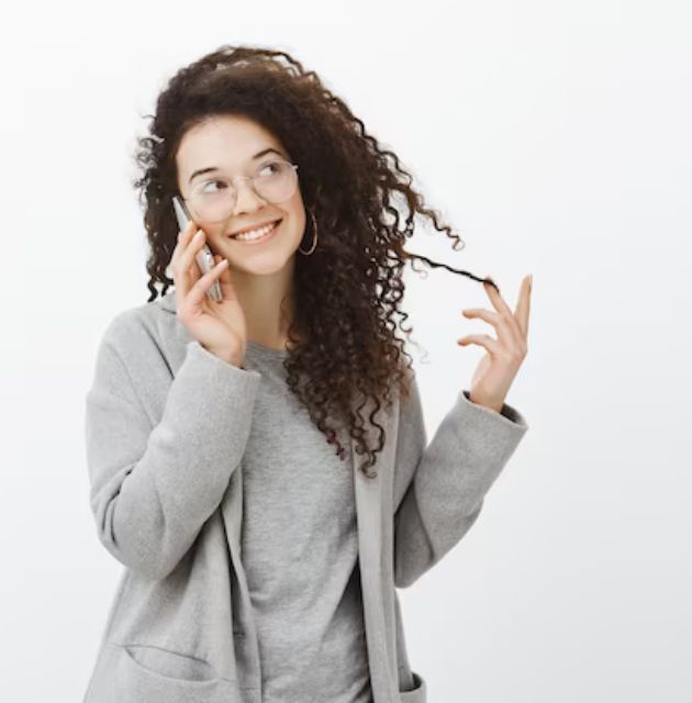 "Curly-haired person using a diffuser on low heat to dry their hair while minimizing frizz."