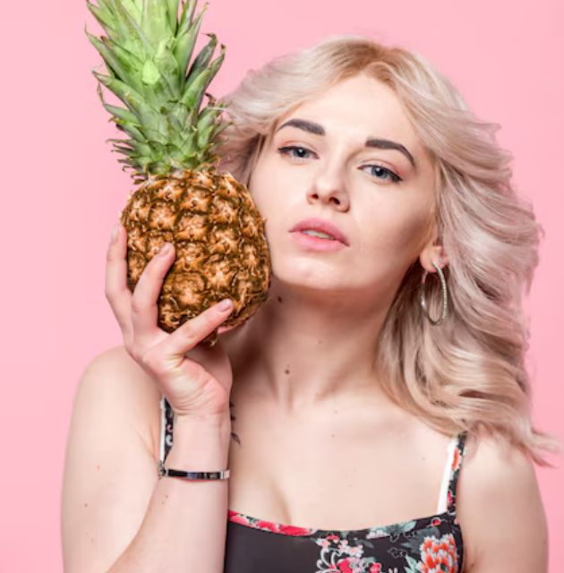  "Close-up of a multi-pineapple hairstyle, showing several small ponytails on top of the head to protect curls."