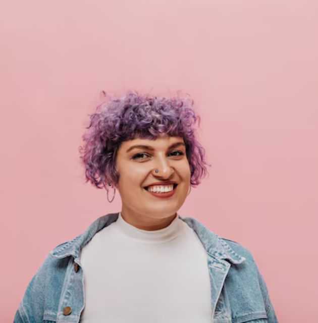  "Curly-haired individual using a cotton T-shirt to plop their curls, preparing for drying."