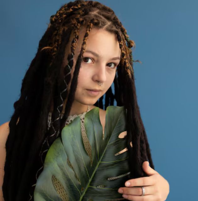 "Close-up of two-strand twists being created on naturally curly hair, showing the intertwined sections."